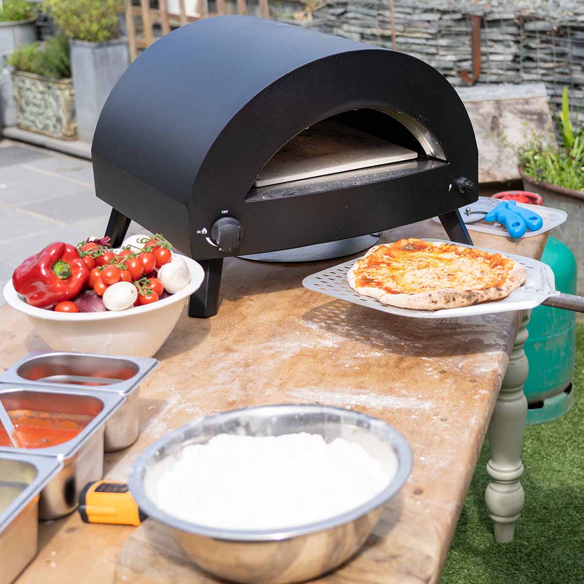 Omica Pizza Oven with pizza cooking